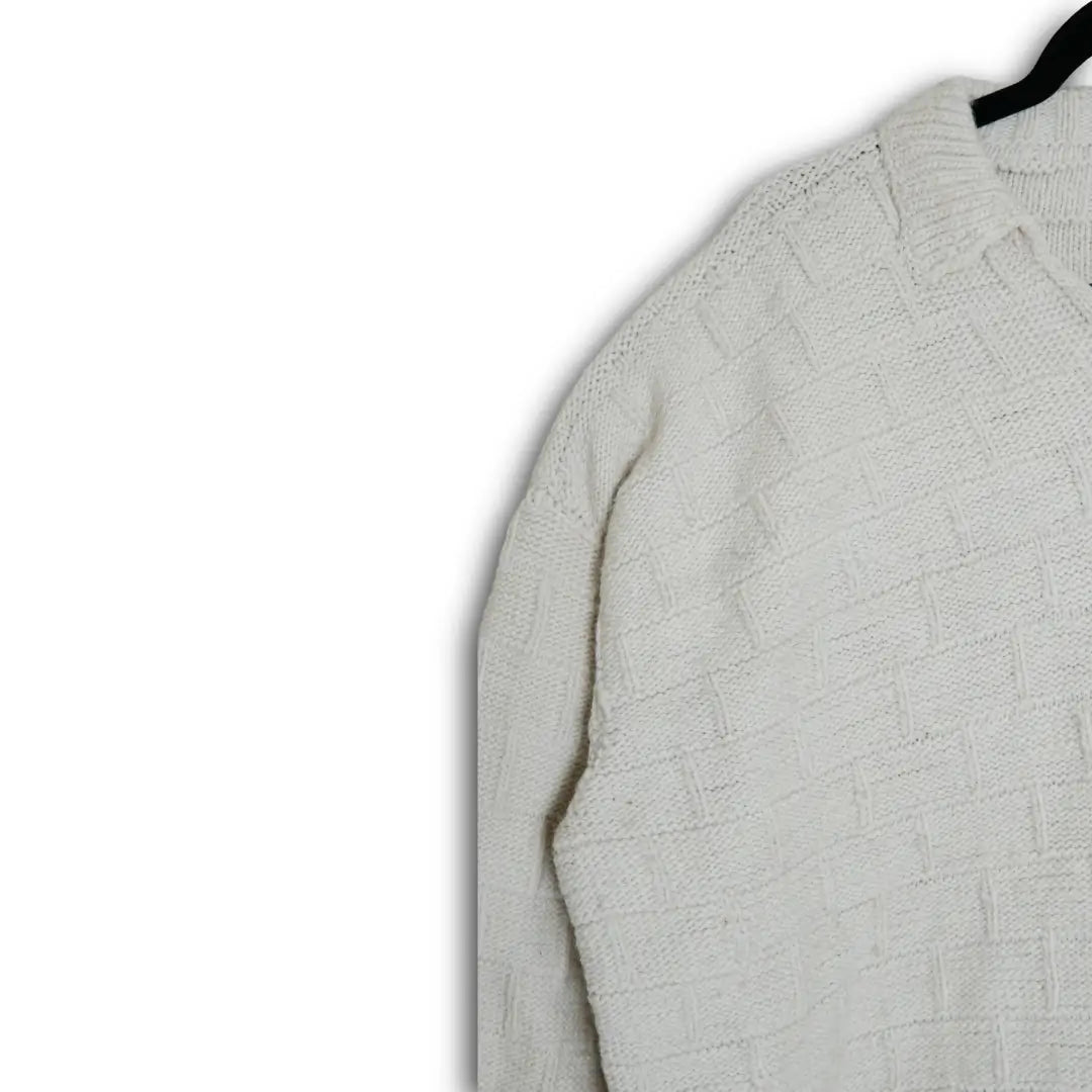 Light gray textured sweater on a hanger against a white background