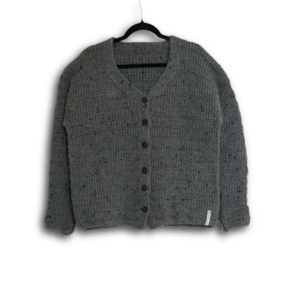 Gray textured cardigan on a hanger against a white background