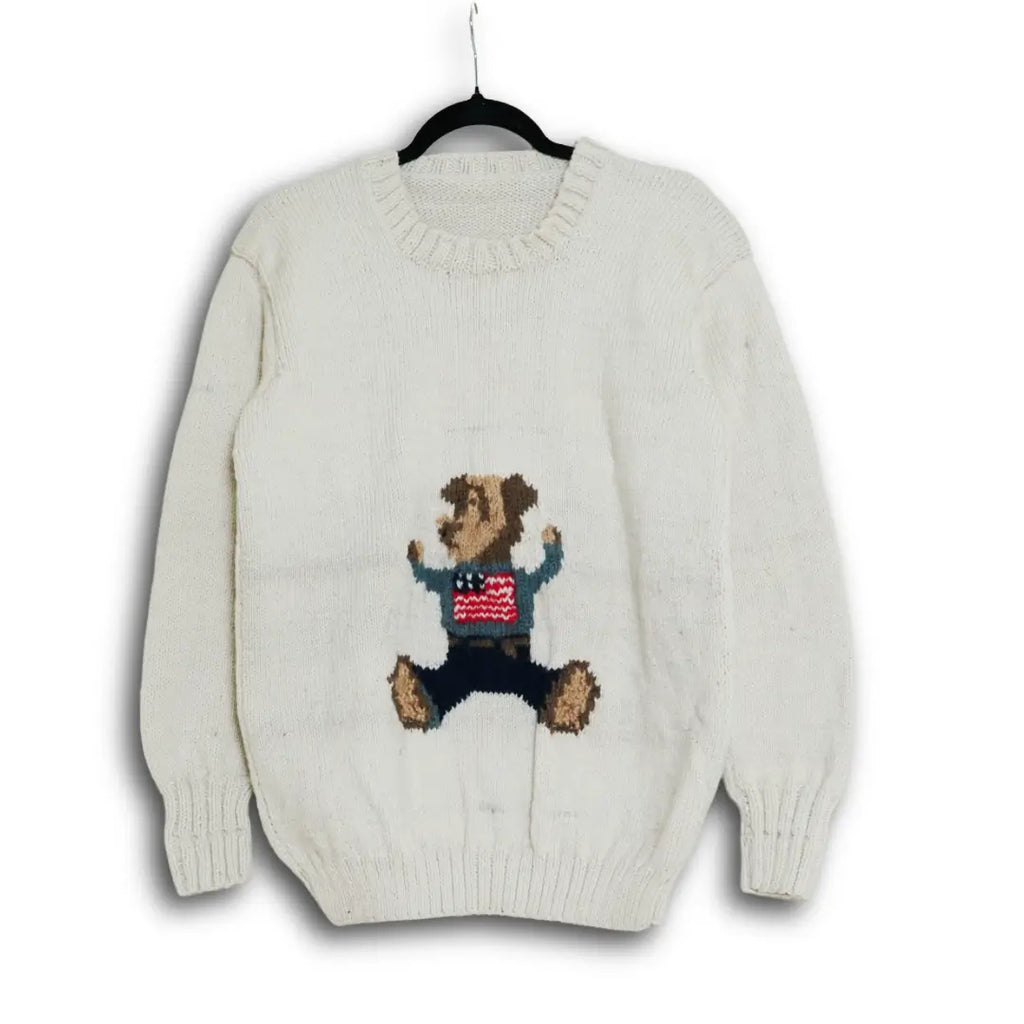 Hand-knitted cream Himalayan wool sweater with custom intarsia bear motif, ethically made by indigenous Lahaul Valley artisans for sustainable boutique fashion brands.