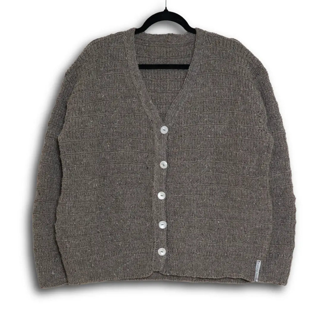 Gray cardigan on a hanger against a white background