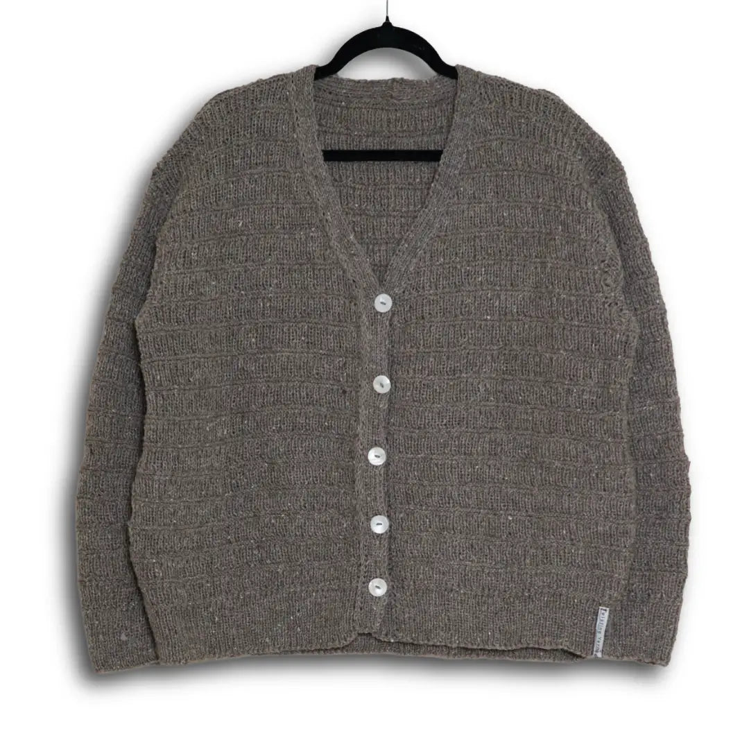 Gray cardigan on a hanger against a white background