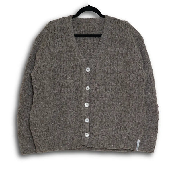 Gray cardigan on a hanger against a white background