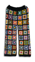 Colorful crochet patterned pants on a black background