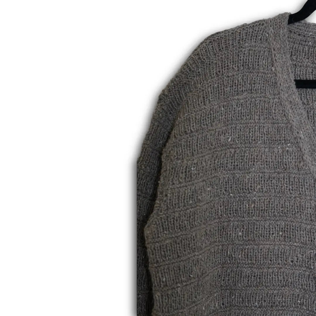 Gray textured sweater on a hanger against a white background