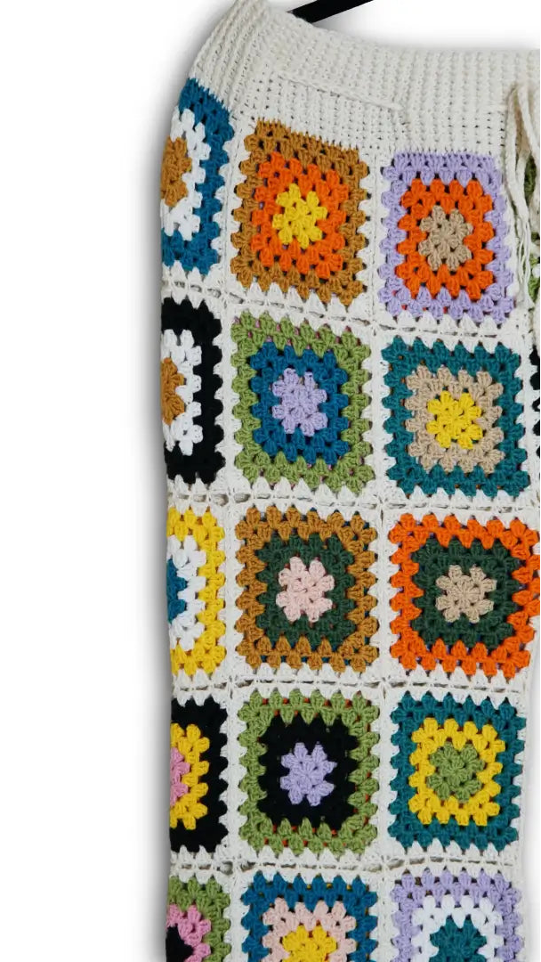 Colorful crocheted  with square patterns on a white background