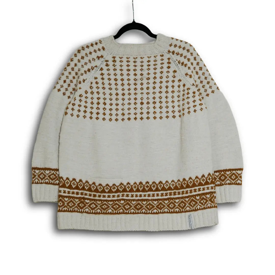 White sweater with brown pattern on a hanger against a white background